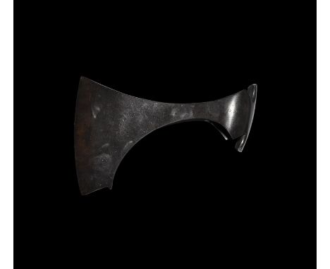 9th-11th century AD. An iron axehead with triangular-section blade widening to a broad bevelled edge with square chin and spu