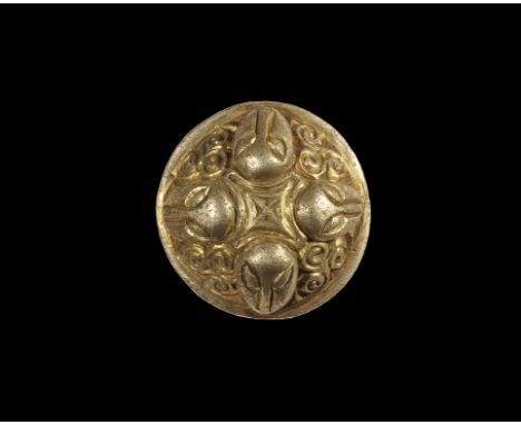 4th-5th century AD. A parcel-gilt silver domed plaque with spike to the underside, flange rim, central cross-in-lozenge motif