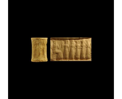 24th-22nd century BC. A large carved shell cylinder seal with engraved design of a seated sun-god with arms raised facing a p