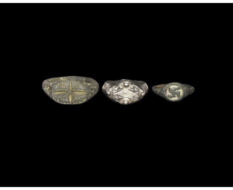 12th-15th century AD. A mixed group of finger rings comprising: one with D-section hoop, hatched shoulders, discoid plaque wi
