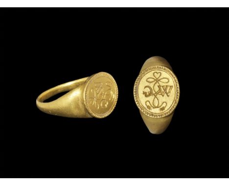 Mid 16th century AD. A shallow D-section gold hoop with expanding shoulders supporting an oval bezel with beaded and lined bo
