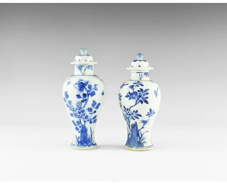 Kangxi Period, Late 17th century AD. A pair of blue and white glazed ceramic meiping vases, each with bell-shaped lid and kno