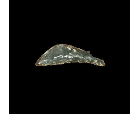 Neolithic, 5th-3rd millennium BC. A finely knapped bifacial sickle knife of crescentic form, the slightly concave cutting edg