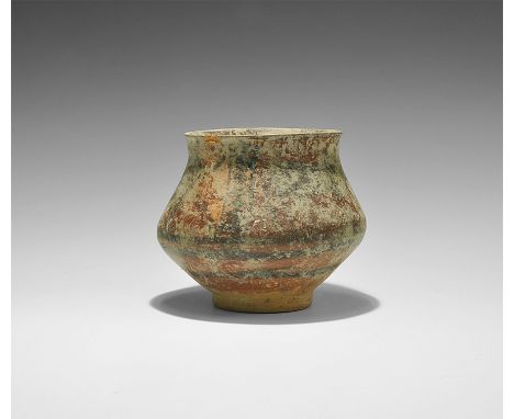 3rd millennium BC. A squat ceramic jar, biconical in profile with basal ring and everted rim, frieze of black advancing bulls
