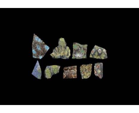 Roman Period, 30 BC-323 AD. A mixed group of mainly flat-section glass fragments, each with floral designs in mosaic or mille