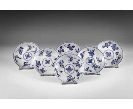 Kangxi Period, Late 17th century AD. A group of six blue and white glazed ceramic saucers with blossom and chrysanthemum deco