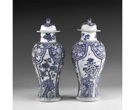 Kangxi Period, Late 17th century AD. A pair of blue and white glazed ceramic meiping vases, each with bell-shaped lid and kno