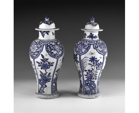 Kangxi Period, Late 17th century AD. A pair of blue and white glazed ceramic meiping vases, each with bell-shaped lid and kno