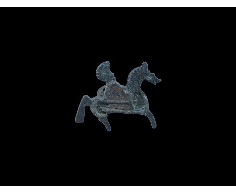 2nd century AD. A flat-section plate brooch of a horse and rider with panels to the cloak and horse's body for enamel fill; n