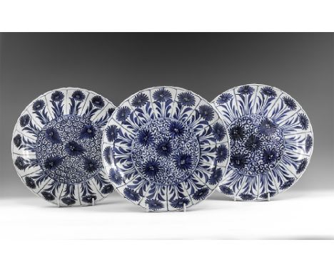 Kangxi Period, Late 17th century AD. A group of three blue and white glazed ceramic lotus dishes with central dense chrysanth