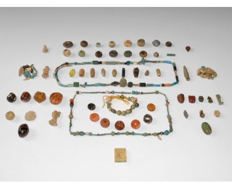 Late Period, 664-332 BC. A large group of stone, glass, ceramic, glazed composition and wood beads and pendants, ancient and 