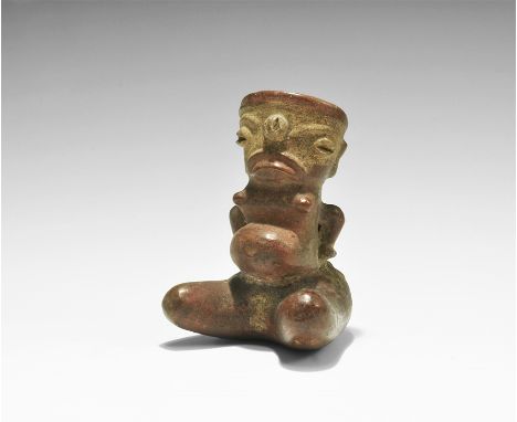 100-700 AD. A hollow-formed glazed ceramic vessel depicting a seated pregnant female with distended stomach and breasts, arms
