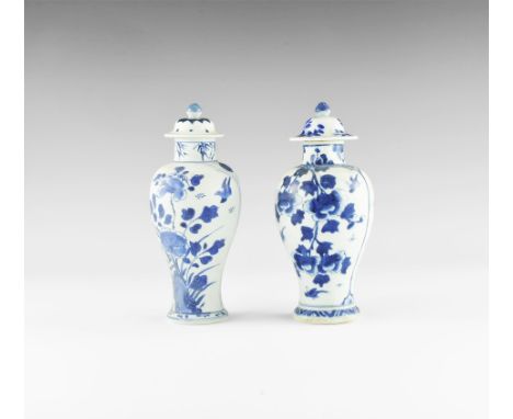 Kangxi Period, Late 17th century AD. A pair of blue and white glazed ceramic meiping vases, each with bell-shaped lid and kno