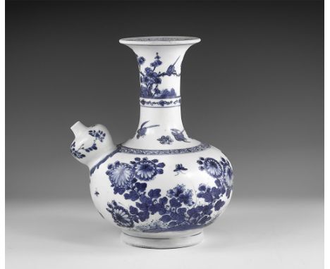 Kangxi Period, Late 17th century AD. A blue and white glazed ceramic kendi wine pitcher with chrysanthemums, blossom and butt