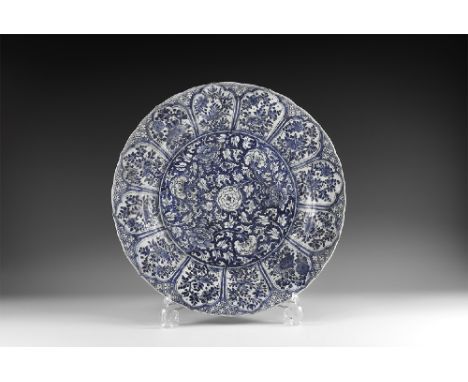 Kangxi Period, Late 17th century AD. A blue and white glazed ceramic lotus charger with central dense chrysanthemum and tendr