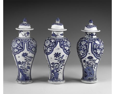 Kangxi Period, Late 17th century AD. A trio of blue and white glazed ceramic meiping vases, each with bell-shaped lid and kno