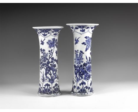 Kangxi Period, Late 17th century AD. A pair of blue and white glazed ceramic beaker vases, each with two large panels of flow