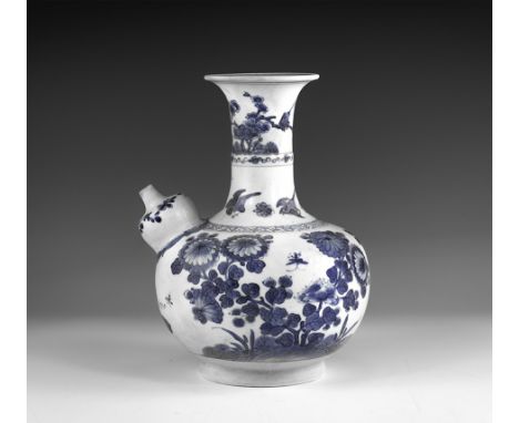 Kangxi Period, Late 17th century AD. A blue and white glazed ceramic kendi wine pitcher with chrysanthemums, blossom and butt