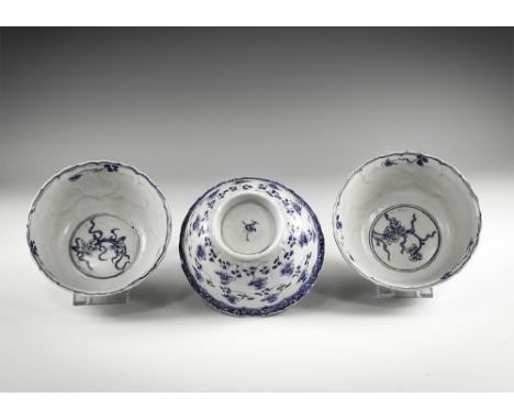 Kangxi Period, Late 17th century AD. A group of three blue and white glazed ceramic lotus bowls with barbed rim, floral motif