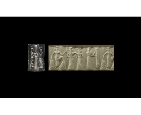 2200-2100 BC. A hardstone cylinder seal with frieze of figures comprising: the sun-god with rays of light emanating from his 