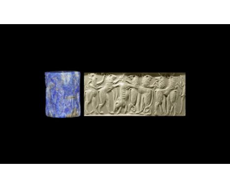 Early 3rd millennium BC. A lapis lazuli cylinder seal with a dense frieze of lions on their hind-legs and an inverted ibex gr
