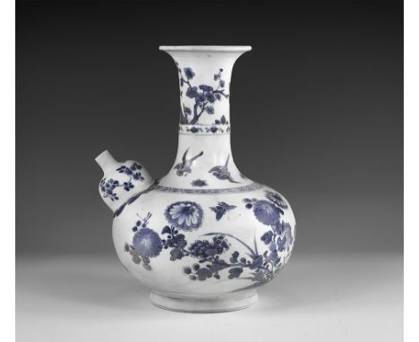 Kangxi Period, Late 17th century AD. A blue and white glazed ceramic kendi wine pitcher with chrysanthemums, blossom and butt