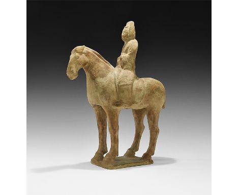 Tang Dynasty, 618-906 AD, or later. A provincial ceramic figurine of horse and rider on a rectangular base; the horse standin