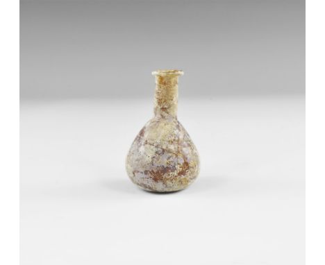 2nd-3rd century AD. An amber coloured glass flask with bulbous body, barrel-shaped neck and everted rim. UK art market, acqui