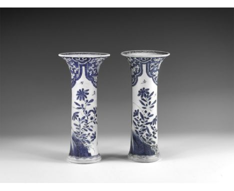 Kangxi Period, Late 17th century AD. A pair of blue and white glazed ceramic beaker vases, each with hatching to the rim, two