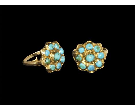 19th century AD. A D-section gold hoop with trefoil shoulders supporting a florid dished plaque with segmented underside, ros