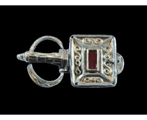 6th century AD. A rectangular silver-gilt plaque with central rectangular cell with cloison garnet and four panel of scroll d