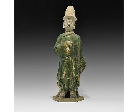 Ming Dynasty, 1368-1644 AD. A large hollow-formed green-glazed ceramic figurine on a hexagonal base in loose robe, holding th