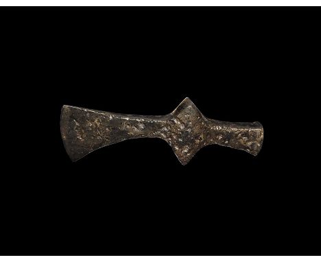 10th-12th century AD. A hand-forged iron axehead with narrow blade, curved edge, lozenge wings to the socket, hammer-head to 