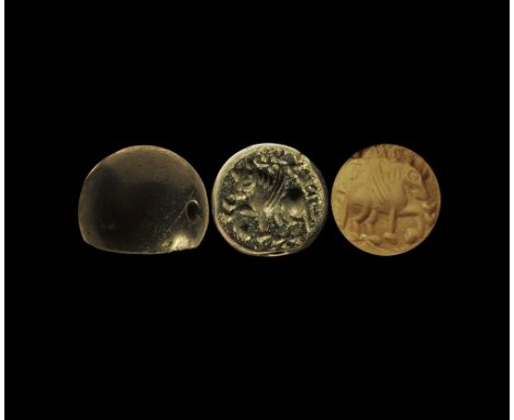 4th-6th century AD. A plano-convex green jasper stamp seal with intaglio winged bull and text to the border; supplied with a 