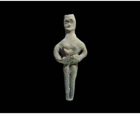 3rd-2nd millennium BC. A ceramic figurine of a standing nude female with a crescent in her hands pressed to her abdomen. Prop