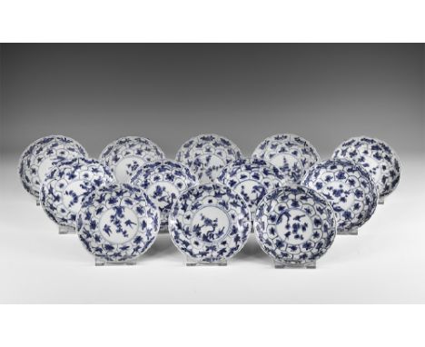 Kangxi Period, Late 17th century AD. A group of twelve blue and white glazed ceramic lotus saucers with flower, bird and inse