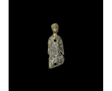 12th-13th century AD. A convex tongue-shaped casket mount with parcel-gilt male head modelled in the round; the plaque formin