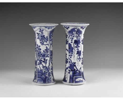 Kangxi Period, Late 17th century AD. A pair of blue and white glazed ceramic beaker vases, each with hatching to the rim, fou