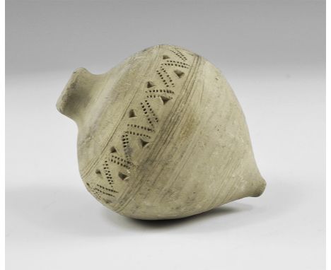 9th-11th century AD. A hollow ceramic vessel decorated with thick conical nozzle and body incised with geometric pattern and 