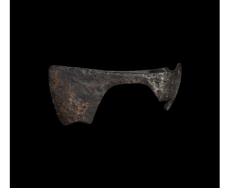 9th-11th century AD. An iron axehead with triangular-section blade widening to a broad bevelled edge with square chin, socket