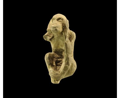 19th Dynasty, 1292-1190 BC. A carved steatite amulet of a seated monkey with bent arms, hands covering the ears; suspension l