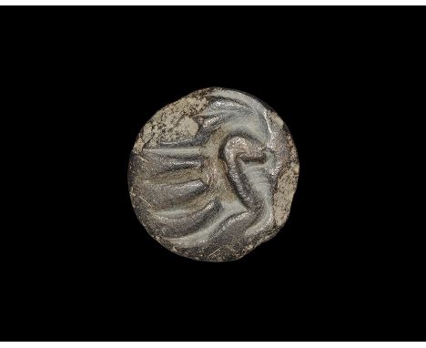 4th millennium BC. A carved steatite plano-convex stamp seal pierced for suspension, with intaglio design of a standing ibex 