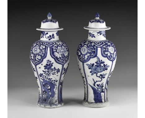 Kangxi Period, Late 17th century AD. A pair of blue and white glazed ceramic meiping vases, each with bell-shaped lid and kno