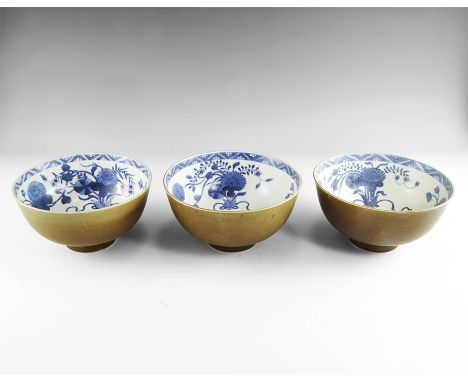 Kangxi Period, Late 17th century AD. A group of three ceramic bowls, each with olive glazed exterior, white glazed interior w