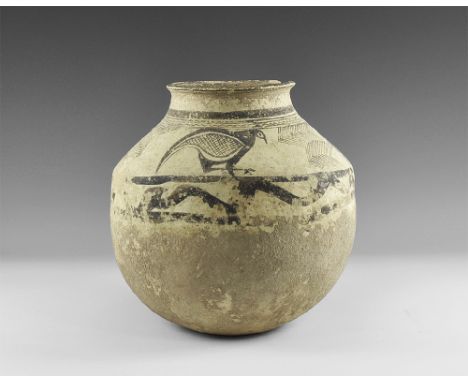 3rd millennium BC. A large creamware ceramic jar with dimple base, sloped shoulder, everted rim; black painted rings to the n