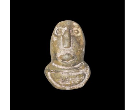 4th century BC. An oval polished stone idol with carved facial features and D-shaped pedestal. Property of a gentleman; acqui