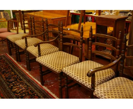 A set of six oak ladder back dining chairs on turned legs with cream upholstery. 