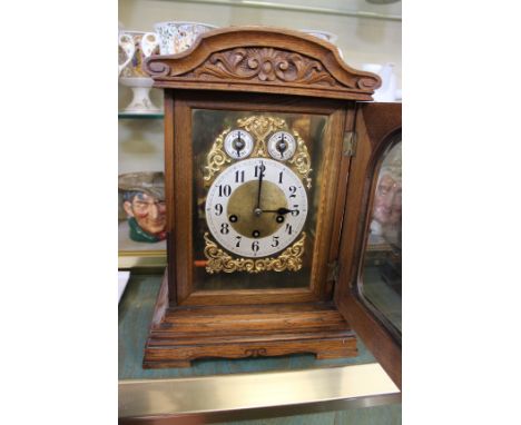 A modern oak mantel clock with ormolu face two subsidiary dials Arabic numeral markers.