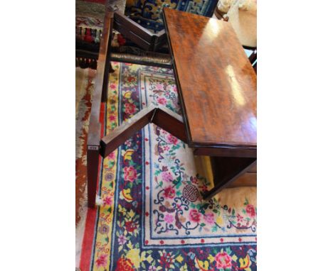 A Geoge III mahogany concertina action card table with baize lining 