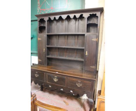 A late Victorian oak George III style dresser with open shelf and cupboard back 215cm high, 152cm wide 